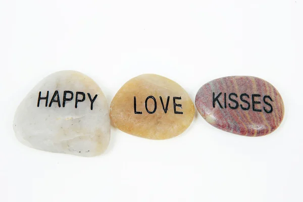 Happy, Love and Kisses engraved on stone — Stock Photo, Image