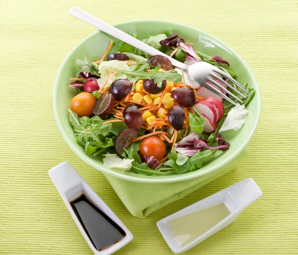 Смешанный салат с ломтиком винограда морковь, руккола, кукуруза и зеленый са — стоковое фото