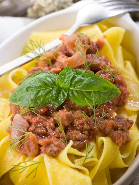Pappardelle bolognese with ragout sauce and basil leaf — Stock Photo, Image