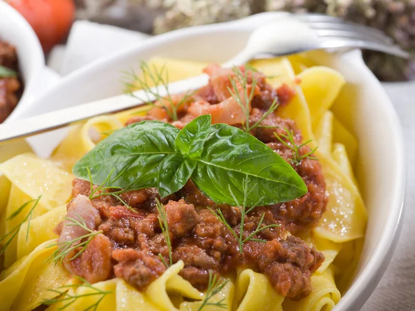 Pappardelle bolognese with ragout sauce and basil leaf — Stock Photo, Image