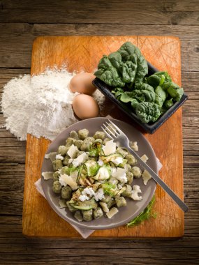 Spinach gnocchi with ricotta zucchinis and parmesan flakes clipart