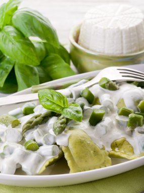 Ravioli stuffed with ricotta and basil garnish with cream and as clipart