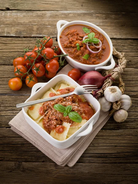 Ravioli with ragout sauce on wooden table — Stock Photo, Image