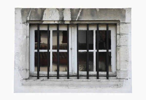 Pequeña ventana blanca con barras negras y piedra sucia —  Fotos de Stock