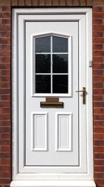 White front door in a red brick building clipart