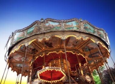 Vintage carousel at sunset in Paris clipart