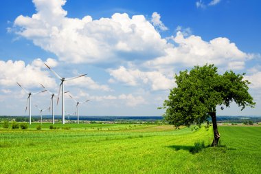 Wind turbine in green nature clipart