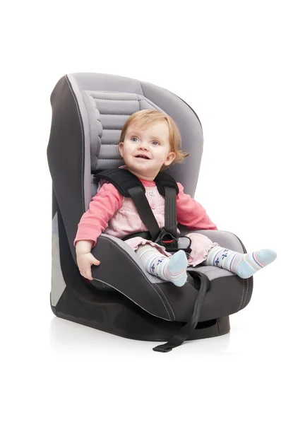 Girl sitting on child's car seat — Stock Photo, Image