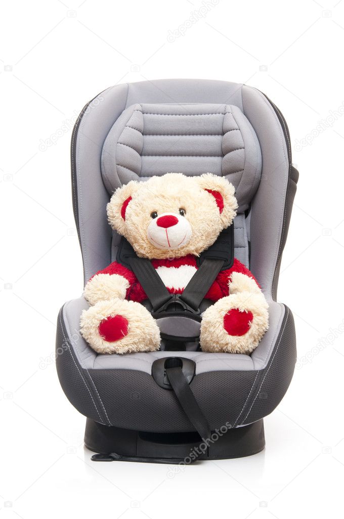 Teddy bear sitting on child's car seat