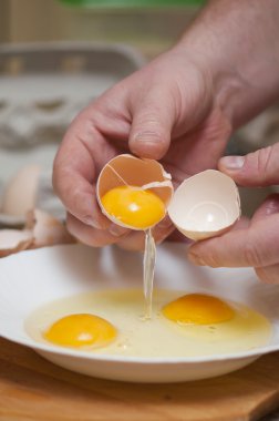 Separating the yolks from the protein clipart