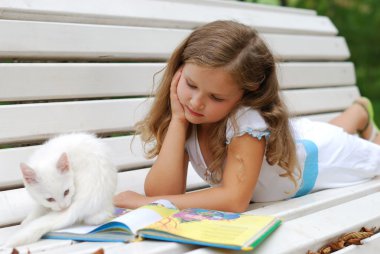 The little girl with a white kitten clipart