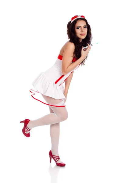Tímido enfermeira sexy segurando uma perna para cima — Fotografia de Stock