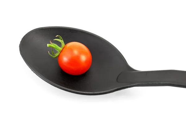 Pomodoro su un cucchiaio nero — Foto Stock