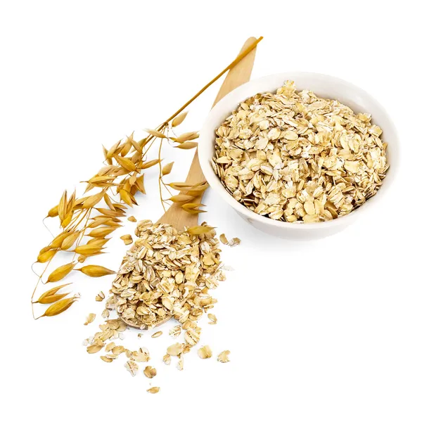 Rolled oats in a bowl and spoon — Stock Photo, Image