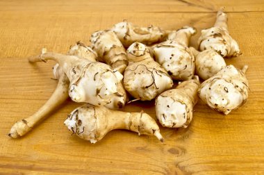 Jerusalem artichokes on the board clipart