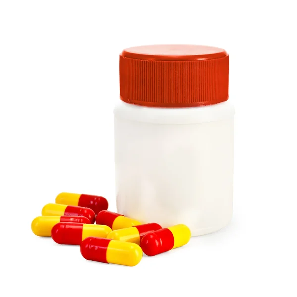 Capsule red and yellow with a jar — Stock Photo, Image