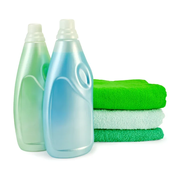 Fabric softener in two bottles and towels — Stock Photo, Image