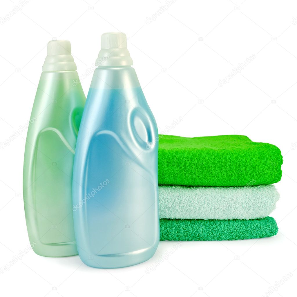 Fabric softener in two bottles and towels