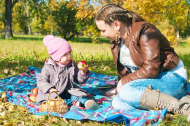 The young woman with the daughter on walk clipart