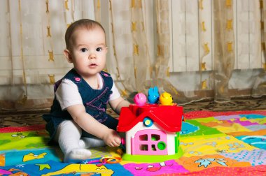 Little girl playing with toys clipart