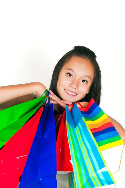A bela menina asiática com pacotes — Fotografia de Stock