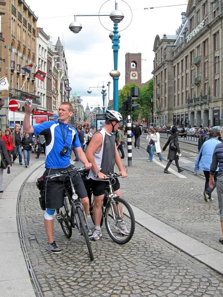 stock image Bike tourists on the stone street making photo on camera, Amsterdam.