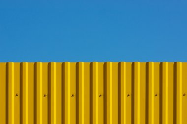 Yellow decking and blue sky clipart