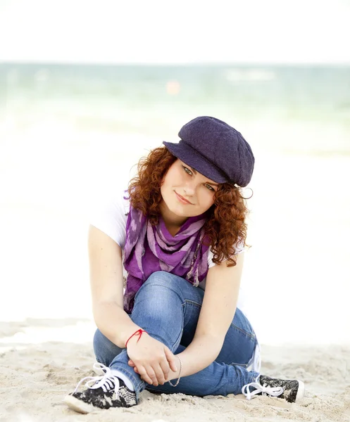 Funny teen girl sitting on the sand at the beach. — Stock Photo, Image