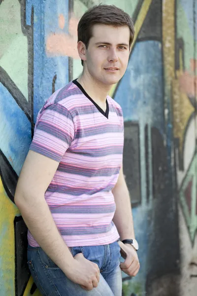 Teen boy near graffiti wall. — Stock Photo, Image