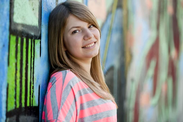 Style teen girl near graffiti wall. — Stock Photo, Image