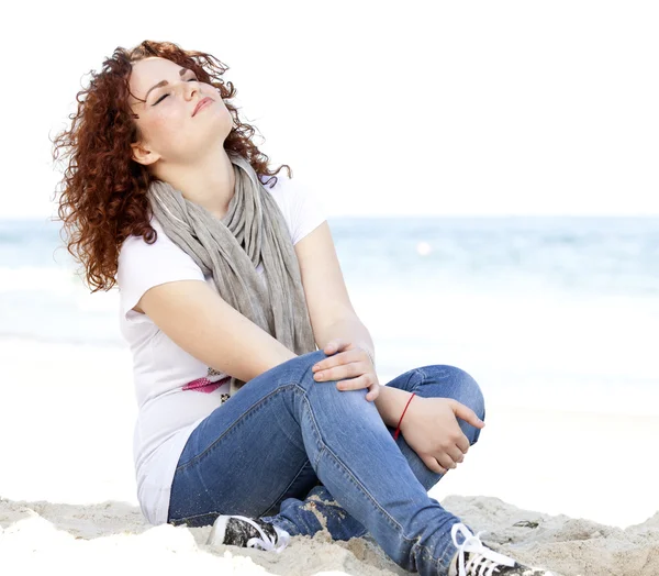 Funny teen girl sitting on the sand at the beach. — Stock Photo, Image