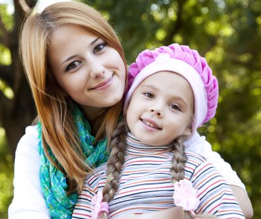 Mother and daughter at the park. clipart