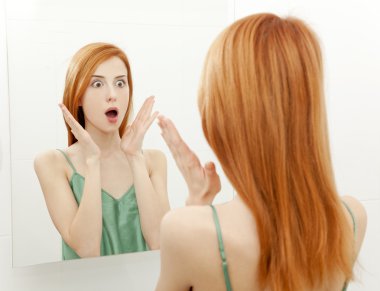 Surprised young woman in bathroom clipart