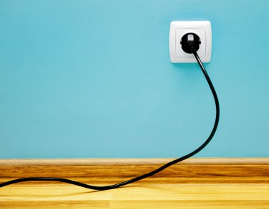Electrical cable into the socket. clipart