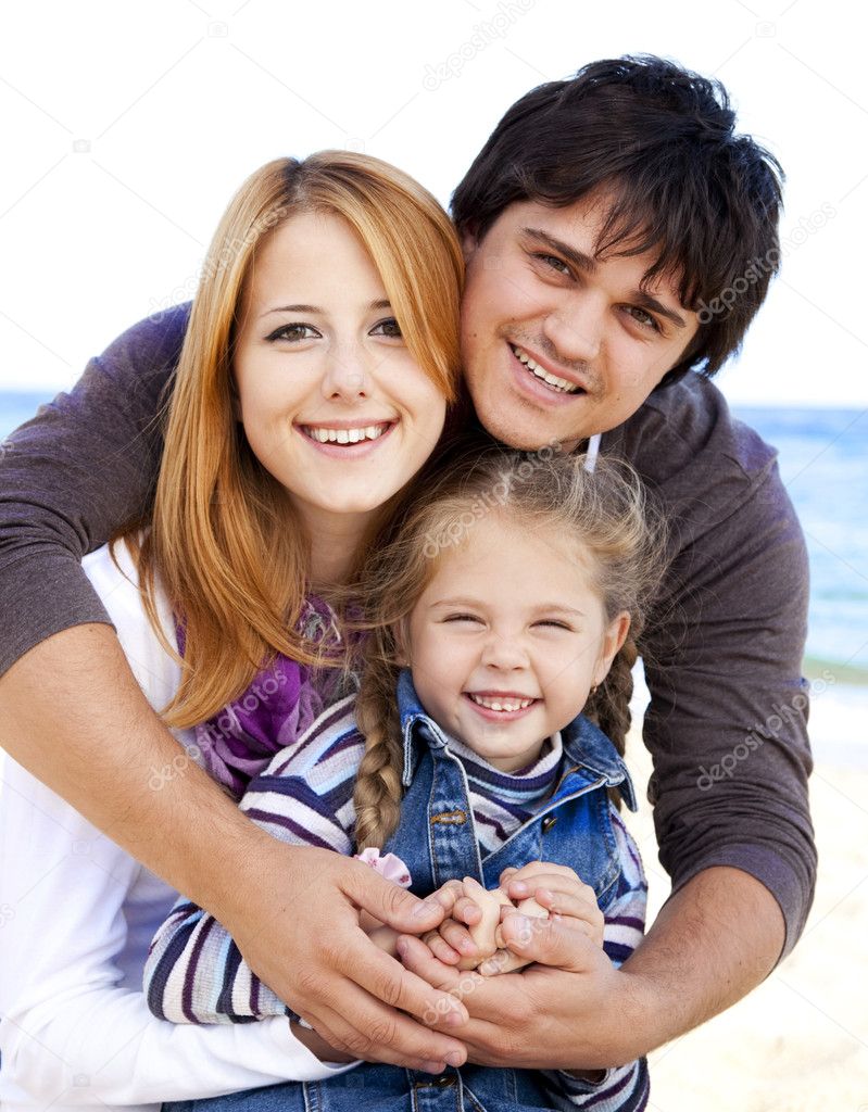 Young family at the beach in fall.