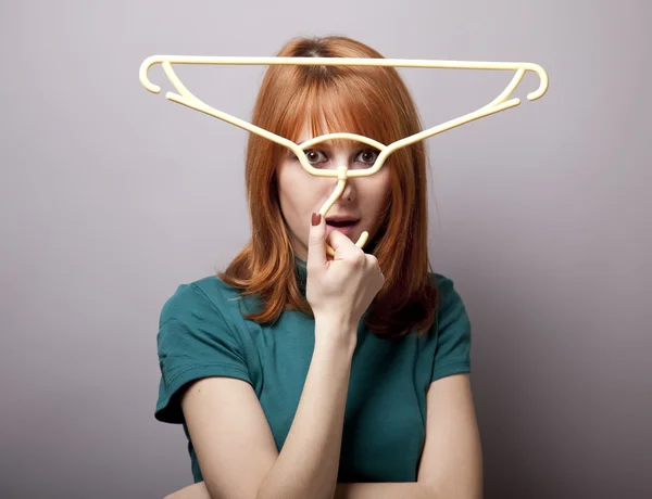 Surprised girl with hanger — Stock Photo, Image
