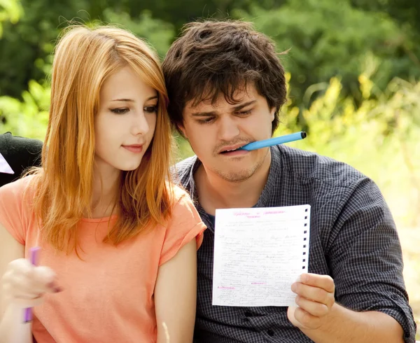 Two students at outdoor doing homework. — Stock Photo, Image