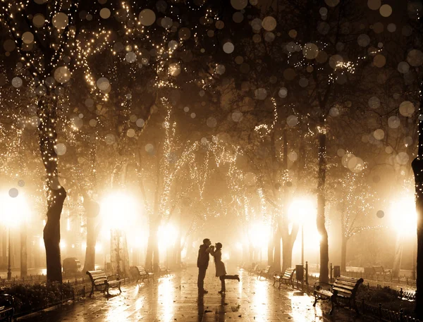 Couple walking at alley in night lights. Photo in vintage multic — Stock Photo, Image