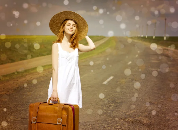 Lonely girl with suitcase at country road. — Stock Photo, Image