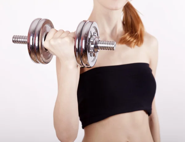 Attractive teenage girl working-out with dumbbells — Stock Photo, Image