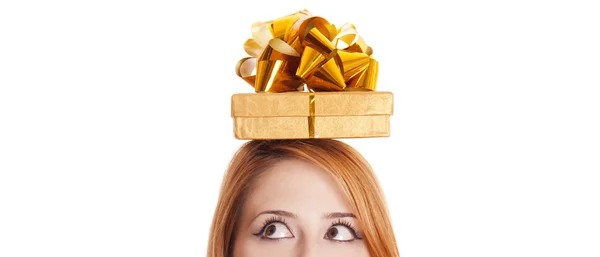 Red-haired girl in dress with present box over head — Stok fotoğraf