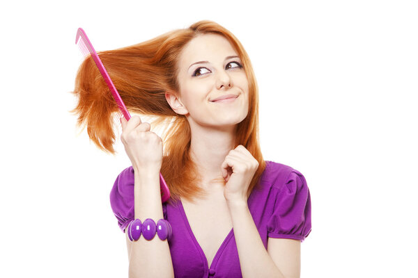 Funny red-haired girl with big comb.