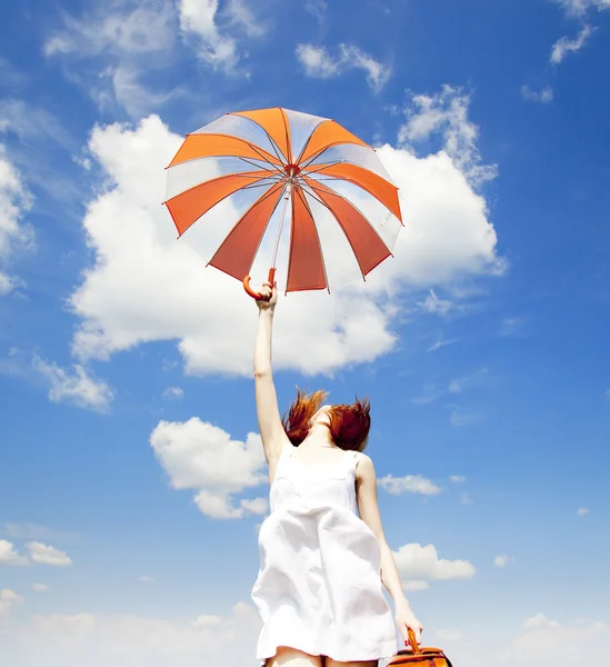 Encantadora pelirroja con paraguas y maleta en primavera —  Fotos de Stock
