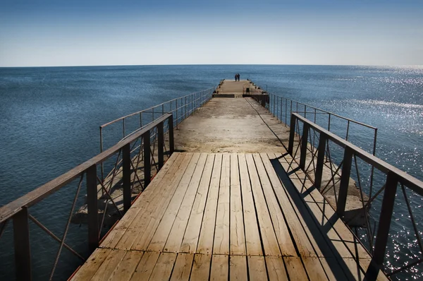 stock image Calm sunset with a jetty on a lake