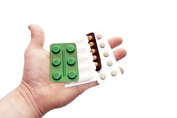 Различные таблетки в руке врача — стоковое фото