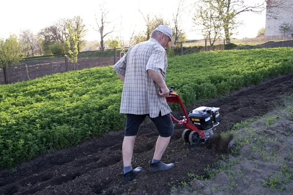 stock image The farmer with a motor-cultivator