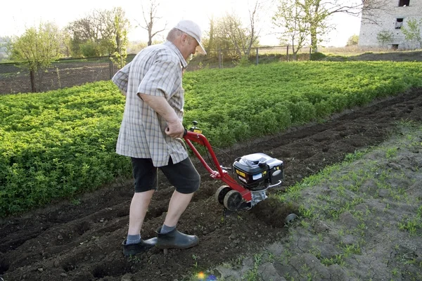 stock image The farmer with a motor-cultivator