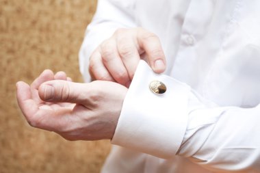 The man clasps cuff links clipart