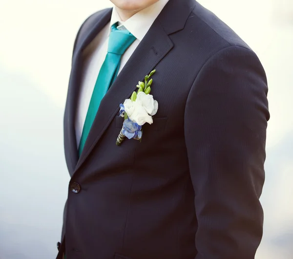 Groom in a wedding jacket with boutonniere Stock Photo