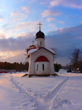Church in the winter at sunset clipart